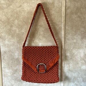Unbranded rusty orange macrame handbag with 25” strap. Measurements: 9”x10”x1”